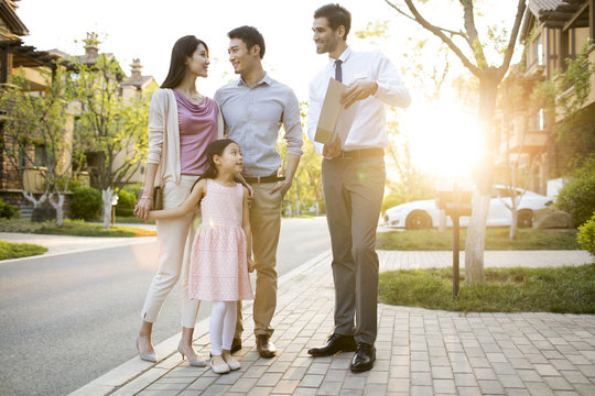Happy young family and confident businessman