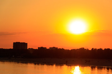 Orange sunset over a river Dnieper in Kremenchug city, Ukraine