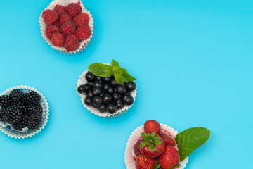 Four fresh fruit tarts with assorted berries