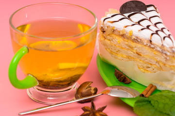 Cup of relaxing spicy lemon tea with layer cake