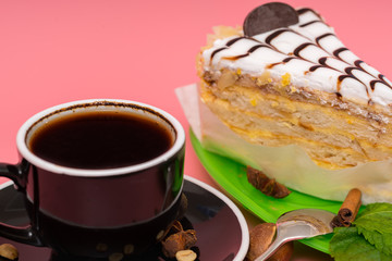 Slice of layered biscuit cake with espresso coffee