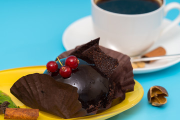 Dark chocolate bonbon garnished with red currants