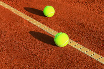 Tennis balls on a tennis clay court © Željko Radojko