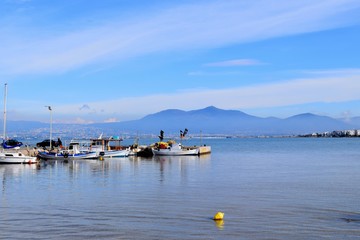 Fototapeta na wymiar Fishing boats in the blue Aegean Sea. Peraia, Thessaloniki, Greece
