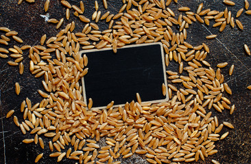 Raw Kamut grain with a small chalkboard