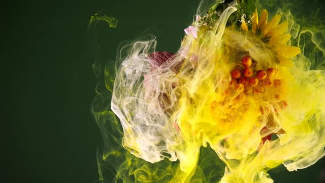 Colorful drops of paint falling on a beautiful autumn bouquet.