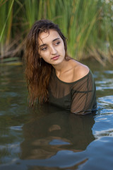 Fototapeta premium summer portrait of a swimming girl, emotional portrait of a girl in the water
