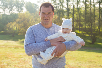 Happy father with the child in the field	