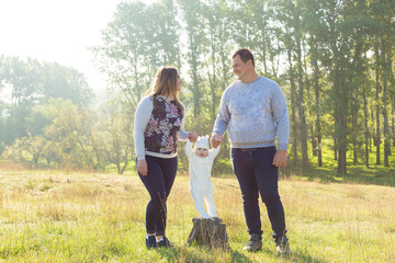 Happy family with the child in the field	