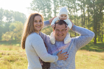 Happy family with the child in the field	