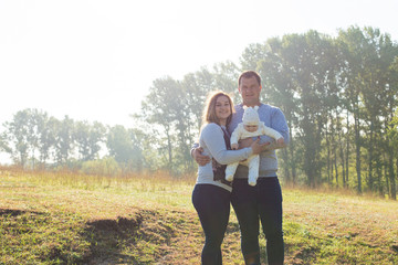 Happy family with the child in the field	