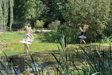 A ballerina made of cloth over a pond in the botanical garden "Aptekarskiy Ogorod" in Moscow, Russia
