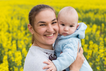 Happy mother with the child in the field	