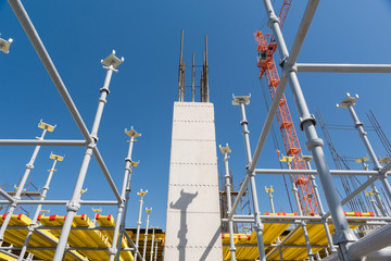 metal concrete structures of the building under construction. scaffolding and supports on a crane background. bottom view