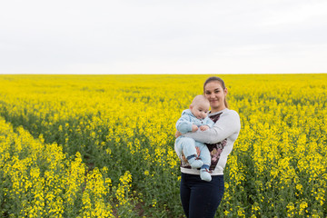 Fototapeta premium Happy mother with the child in the field 