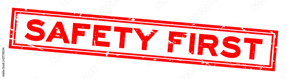 Sticker Grunge red safety first word square rubber seal stamp on white background