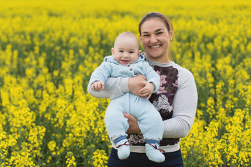 Happy mother with the child in the field	