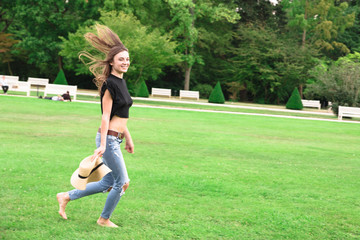 Young beautiful fit woman running in green park