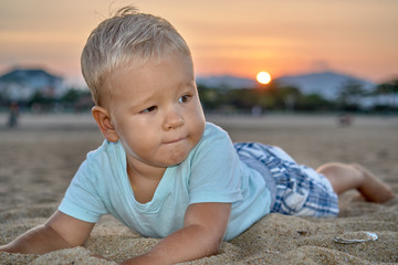 Cute boy sunset portrait on the beach