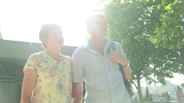 Slow Motion Steady Cam View Of An Active Senior Caucasian Tourist Couple Walking In London Backlit By The Sun Themes Of Sightseeing Active Seniors Direction On The Move