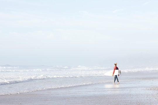 Surfer entering water
