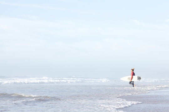 Surfer entering water
