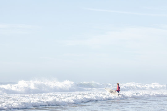 Surfer entering water