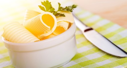 Sliced fresh butter in white bowl