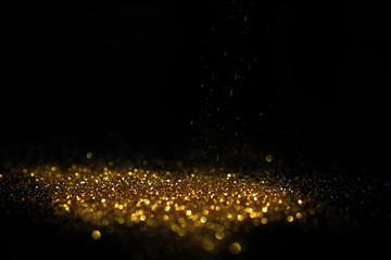 Close up of Gold powder with glitter lights on black background