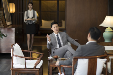 Cheerful businessmen talking in tea room