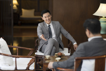 Cheerful businessmen talking in tea room
