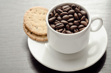A cup of coffee with cookies