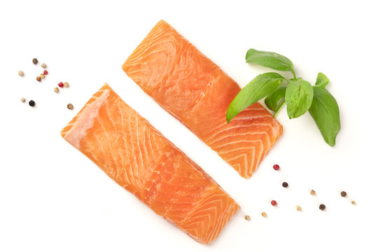 Slices of salmon with basil and pepper, on a white background with copy space, overhead photo