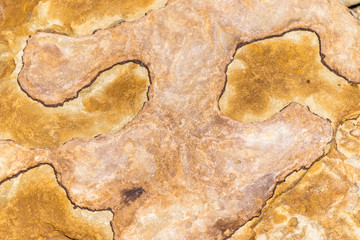 Rough peach and rust colored crystal textured rock background
