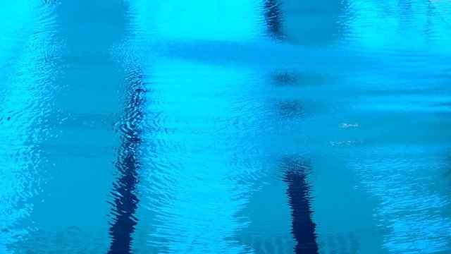Blue surface of water in the empty sport pool  for diving.