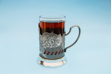 black tea in the сup holder on a blue background