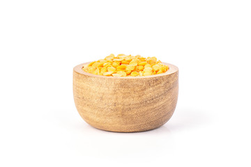 Lot of whole raw red lentils with wooden bowl isolated on white background