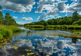 River is summer landscape. Sunny day, blue sky with beautiful clouds.