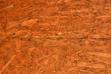 Construction oriented chipboard covered with brown varnish, original woody background-plate