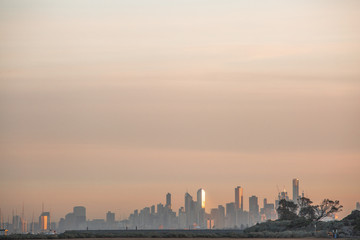 Naklejka premium View of City of Melbourne at Sunrise from Brighton Beach