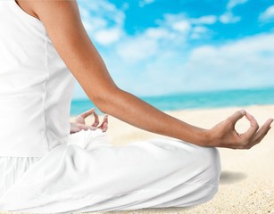 Young beautiful woman doing yoga on background