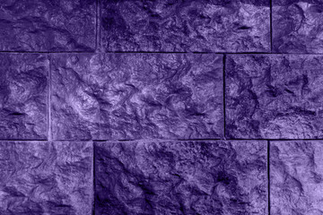 Ultraviolet background, wall from relief brick, unusual texture