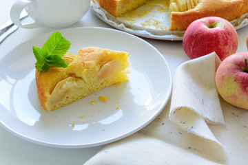 Slice of homemade apple pie on white plate. Tea time concept