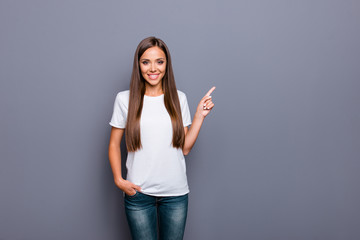 Attractive woman in a white tshirt pointing with her index finge