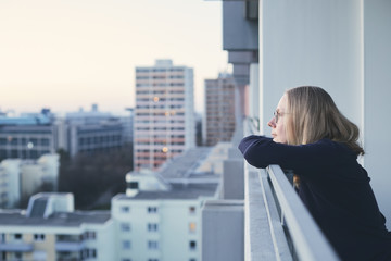 Fototapeta na wymiar Woman on balcony at sunset