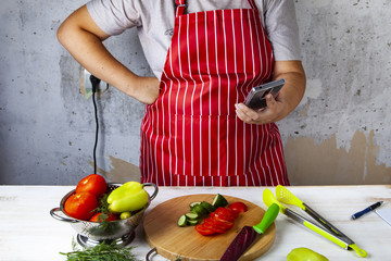 Woman in a red apron with phone