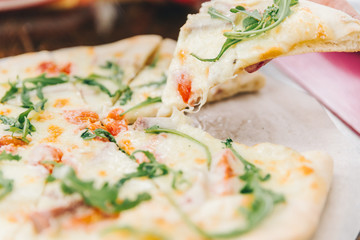 woman take piece of pizza close up. soft focus