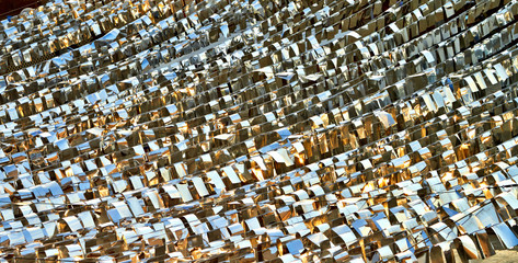 Texture of silver with gold flags evening sun reflection at sunset view from above