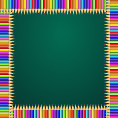 square frame made of colorful rainbow pencils on green blackboard background