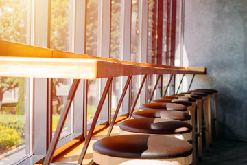 Fototapeta na wymiar interior cafe. Bar stools stand in row near large window